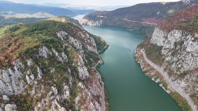 High-altitude panoramic landscape drone footage of the expansive Danube river valley, capturing the majestic scale of the bi-national Iron Gates gorge &ndash; 2026