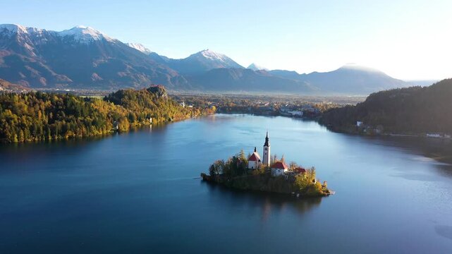 Bled Island church on calm lake in autumn morning light