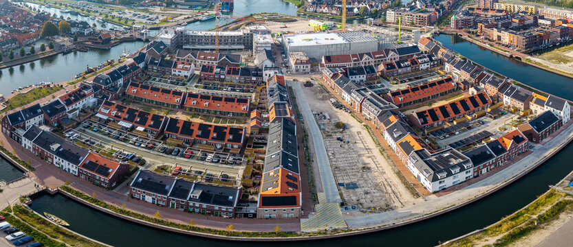 Aerial view of Kop van de Stadswerven residential housing development featuring modern dutch architecture along waterfront in Harderwijk, Gelderland, Netherlands