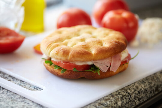 Italian focaccia sandwich with ham, tomato and mozzarella