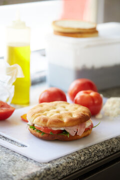 Italian focaccia sandwich with ham tomato and arugula