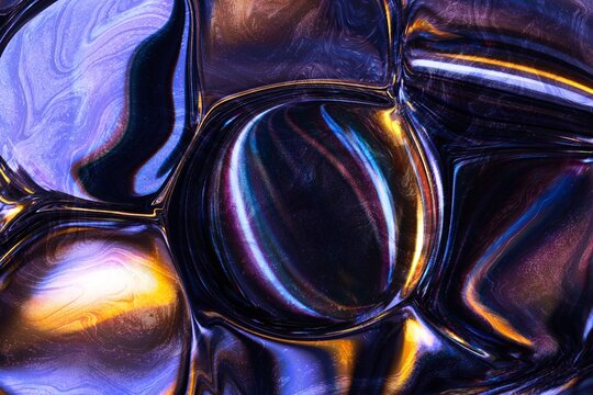 Iridescent metallic abstract texture with flowing reflective forms