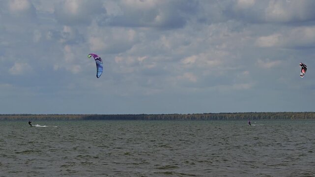 Kitesurfing on the lake on a windy summer day.