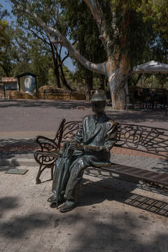 Bronze statue of forestry engineer Francisco Mira y Botella seated on a decorative bench in Parque Alfonso XIII Guardamar del Segura, Alicante