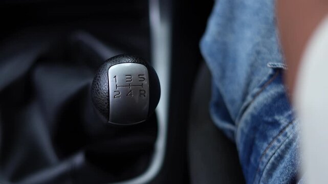 close up hand of car gear stick selector 5 speed. concept transport travel.