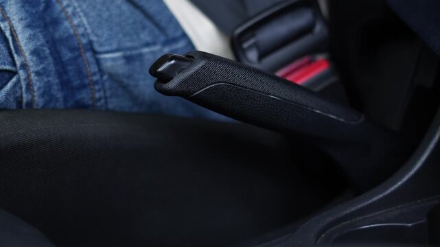 close up hand of handbrake Manual helps your car to stop while parked without having to keep your foot on the brake pedal. concept transport travel.	