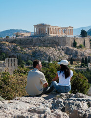 Fototapeta premium Couple enjoying the breathtaking view of the Acropolis in Athens, Greece
