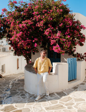Charming lefkes in paros greece with vibrant bougainvillea and rustic pathways