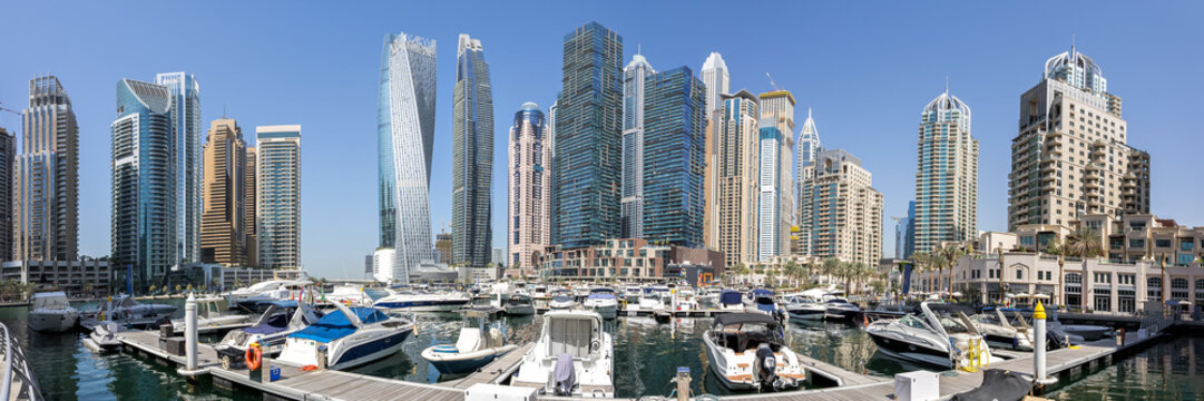 Dubai Marina skyline cityscape panoramic view with yachts hotel skyscraper buildings living at water in Arabia
