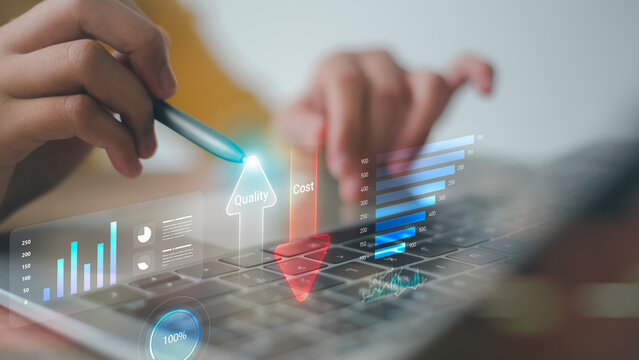 Professional businessman using stylus pen to analyze quality growth and cost reduction charts on laptop virtual screen, optimizing corporate profit and efficiency.