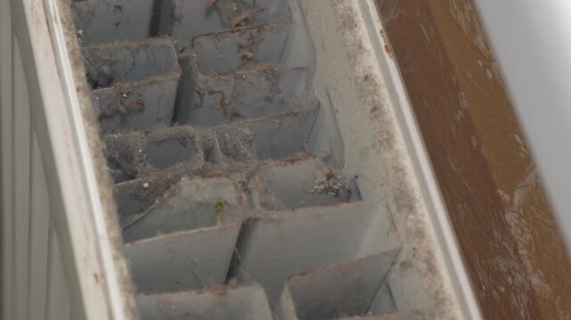 Close-up of the inside of a dirty, dusty radiator, Dust and dirt inside a home radiator