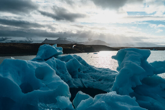 Aerial view of Jokulsarlon glacier lagoon with icebergs floating in the water under a dramatic cloudy sky in Sveitarfelagid Hornaf, Iceland.