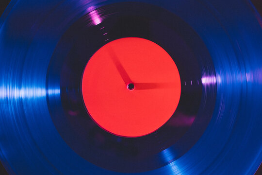 Close up of vinyl record under colorful light