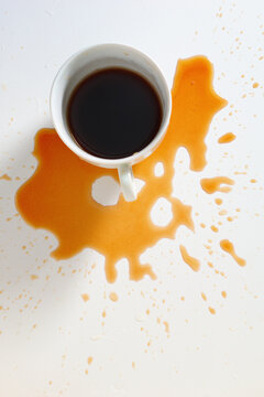 Spilled coffee cup on background