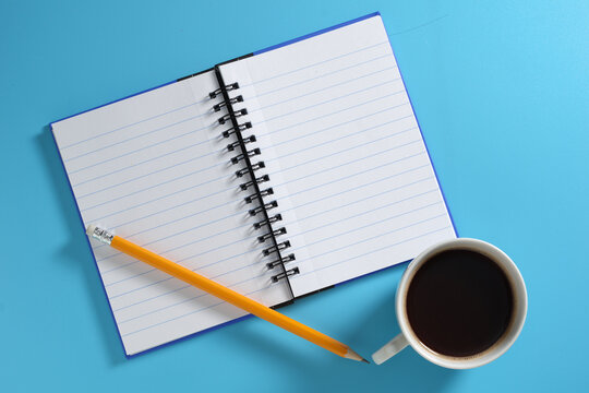 Notebook, Coffee Cup, and Pencil