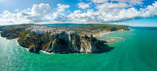 Peschici Gargano Puglia Italy high resolution panorama. Perched cliff town castle over Adriatic sea, vertical drop rock, white old town, distant beach marina World Print poster. © Freesurf