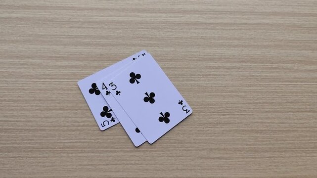 Dealing cards at the table, revealing the poker playing cards.