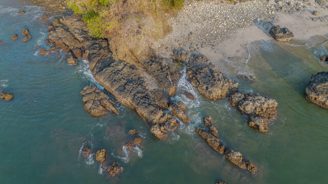 Aerial panoramic view of Pujiharjo beach bay surrounded by green hills in Malang East Java