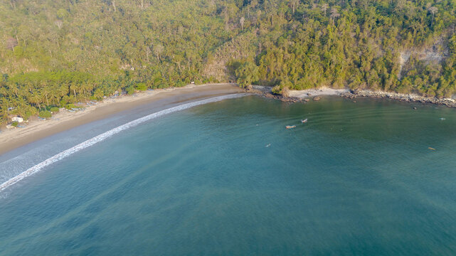 Aerial panoramic view of Pujiharjo beach bay surrounded by green hills in Malang East Java