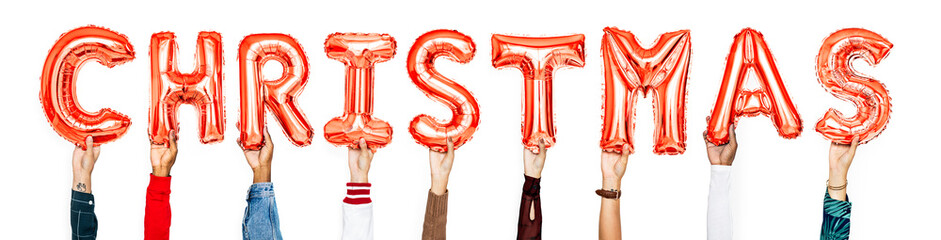 Obraz premium Hands holding balloons spelling Christmas