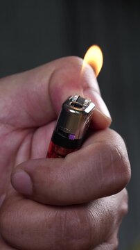 lighting the gas lighter. emits sparks and ignites close up.