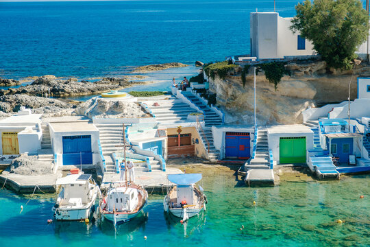 Charming Mandrakia in Milos, Greece with vibrant fishing boats and crystal-clear waters