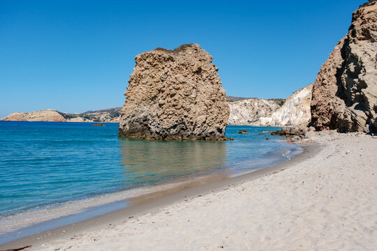 Explore the stunning beauty of Firiplaka Beach in Milos, Greece on a sunny day
