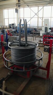 Steel wire unwinding from coils and feeding a mesh welding machine at a wire mesh factory