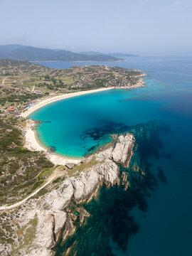 Beautiful aerial view of Kriaritsi Beach in Chalkidiki, Greece with turquoise waters and cliffs