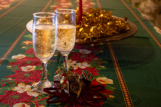 Christmas Eve table displaying two glasses of sparkling wine, creating a festive atmosphere for holiday celebration and traditions.