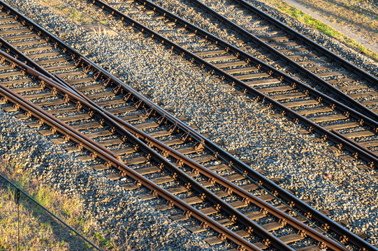 Railway track junction with wooden sleepers and gravel. Industrial background for logistics and cargo topics