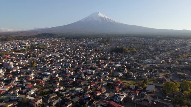 Aerial view of Mount Fuji towering over Fujiyoshida city in Yamanashi, Japan.