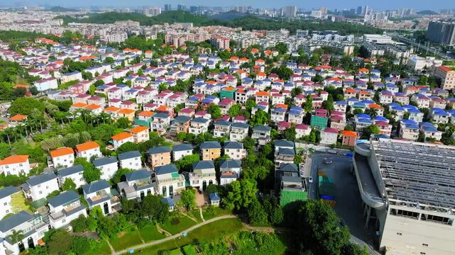 Dense villa neighborhood with distant apartments in Guangzhou