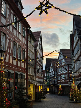 Old market place in Alsfeld, Hesse, Germany with the christmas decoration, old houses with stores, restaurants and visitors of the christmas market. Traditional Christmas market