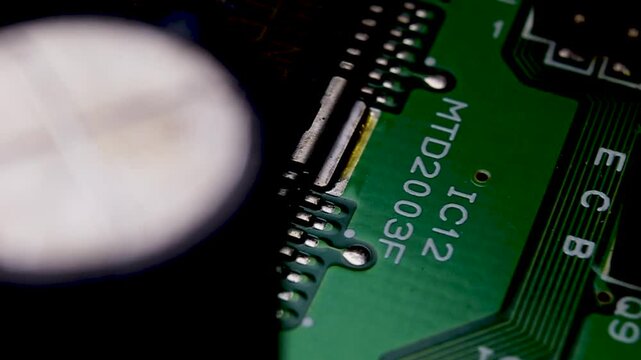 View of a part of an electronic printed circuit board with SMD components and a microcircuit, video macro shooting