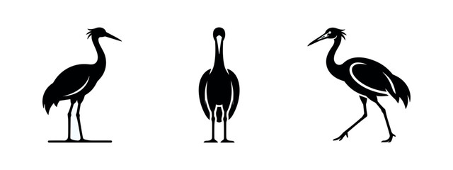 Obraz premium Set of elegant black crane or stork bird silhouettes in various poses on white background, ideal for minimalist designs.