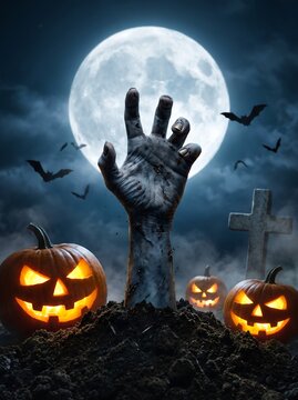 Halloween zombie hand rising from grave with glowing jack-o-lanterns under a full moon night sky