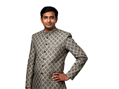 Distinguished Indian man in a patterned beige bandhgala jacket, confidently posed with hand on hip, isolated on a transparent background