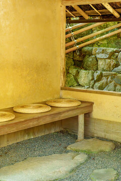Traditional Japanese Rest Area with Mud Wall and Round Straw Cushions