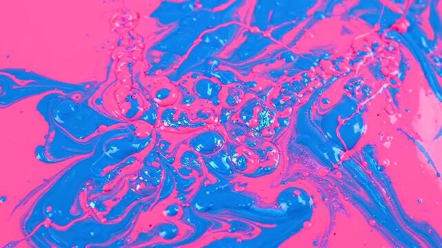 Vibrant pink and blue liquid paint swirls: abstract fluid motion background