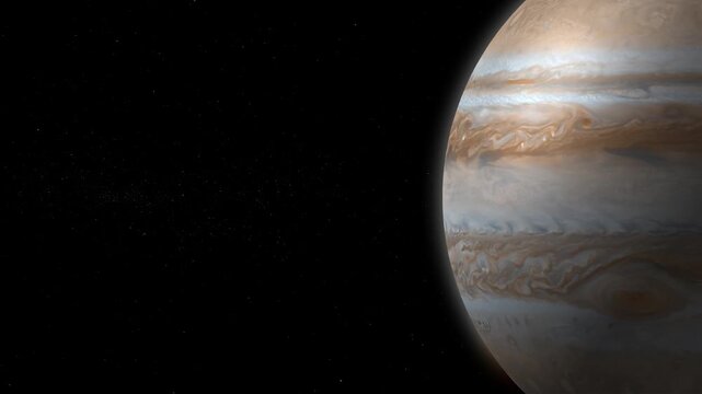 Jupiter rotating against a star-filled background in deep space with copy space