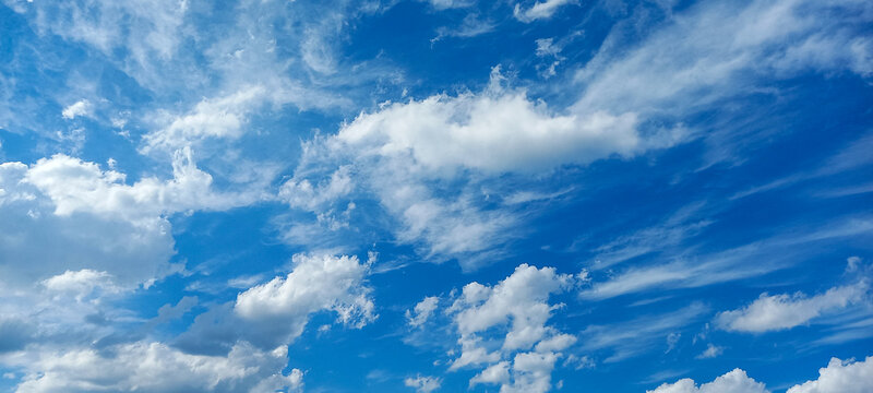 Bright Blue Sky with Fluffy White Clouds on a Sunny Day