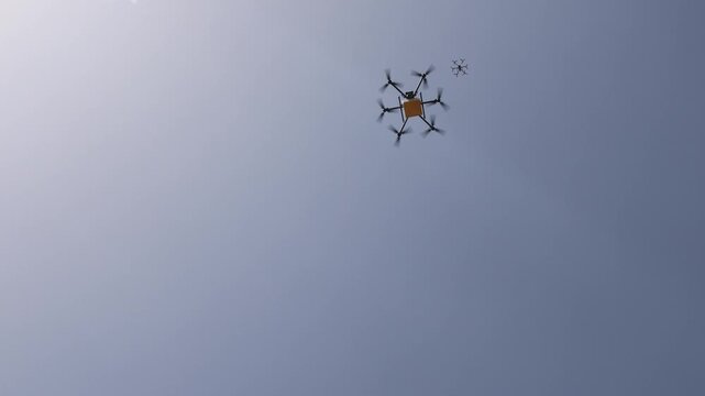 View of a delivery drone flying against a clear blue sky in Shenzhen, Guangdong Province, China.
