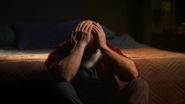 Middle-aged widower cries while sitting on floor, coping with grief and loss