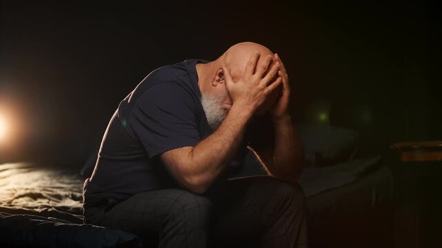 Lonely middle-aged man cries after divorce at home, coping with deep pain