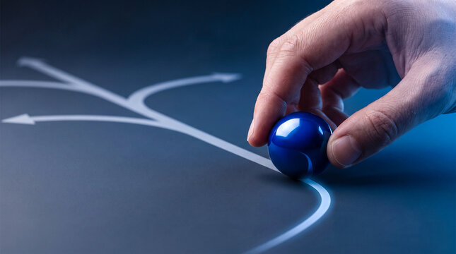 Person holding blue marble at starting point of branching path lines representing career decision making business strategy planning and strategic direction choices.