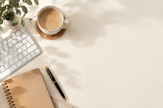Coffee Cup, Notebook, and Keyboard on a Desk With Sunlight
