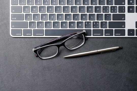 Office supplies on dark leather desk