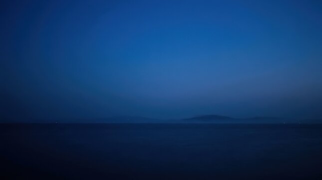 Minimal dark blue horizon with a soft gradient from navy to cobalt, abstract atmospheric photography, barely visible landscape forms, strong negative space, calm nocturnal mood, technology, meditation