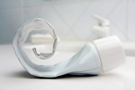 Empty toothpaste tube on a bathroom sink